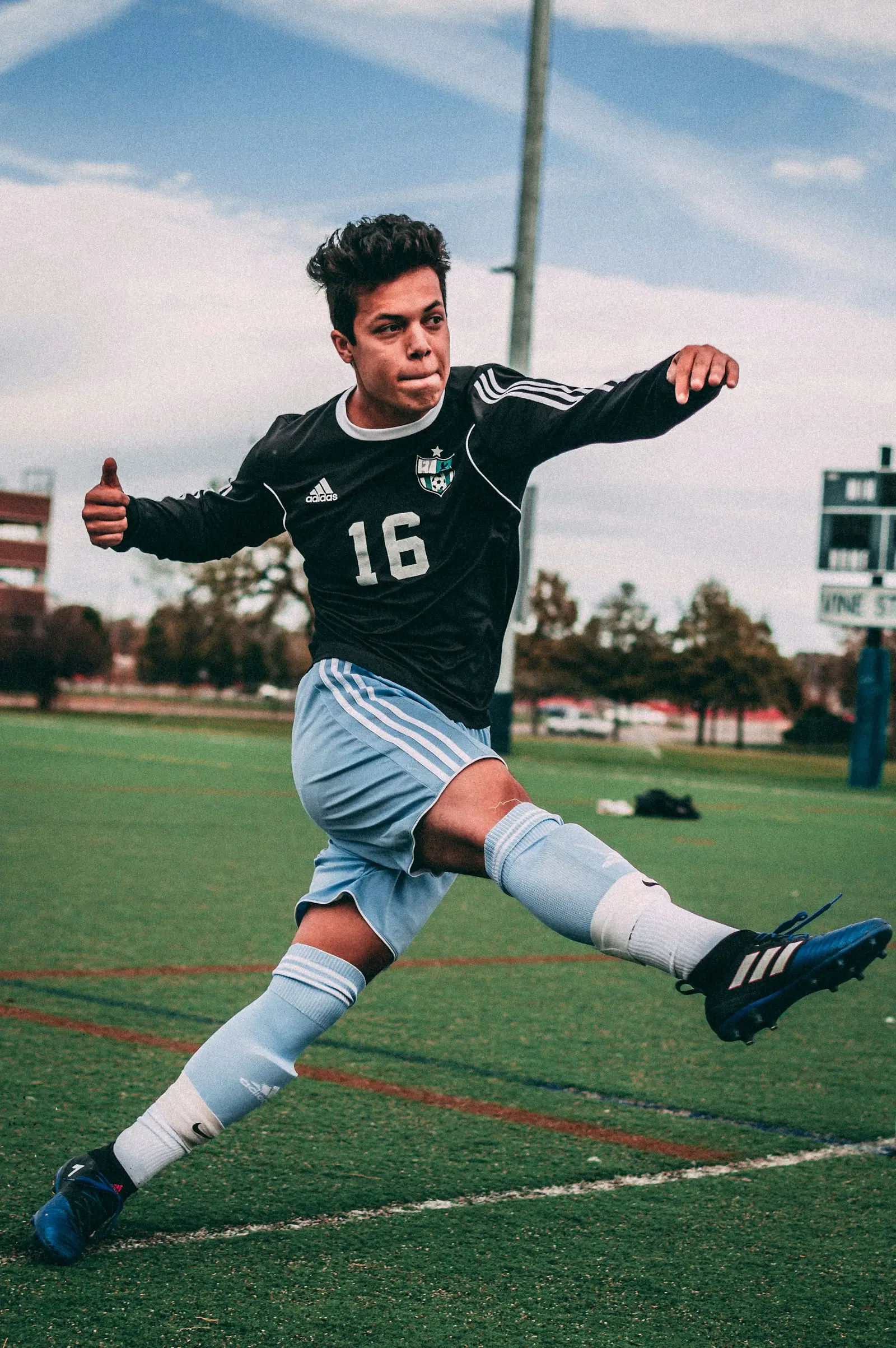 A young player striking the ball during a community training session
