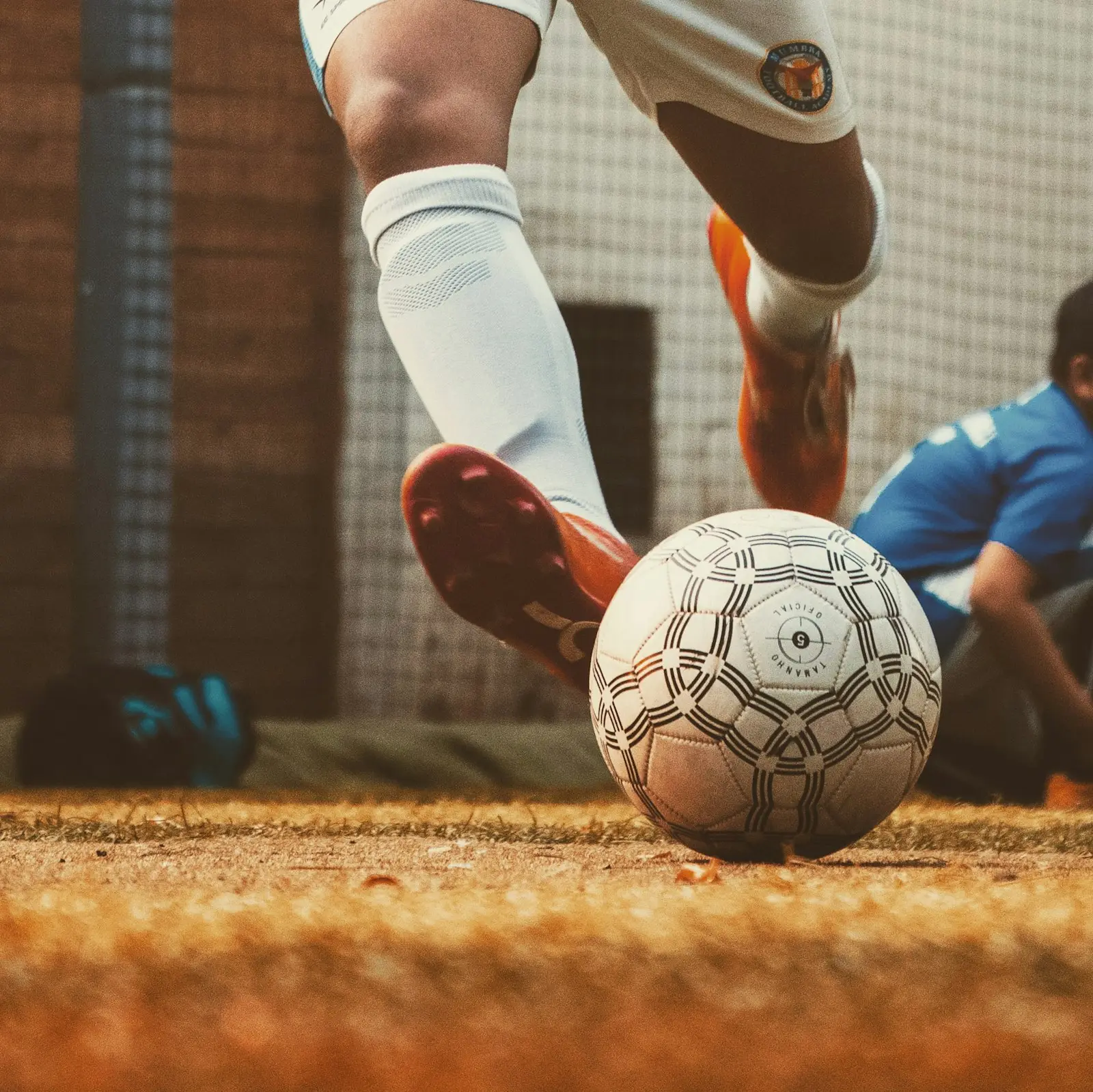 A young player challenging for the ball during a match