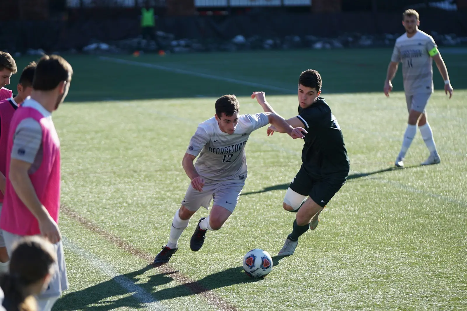 Players competing for the ball during a community match
